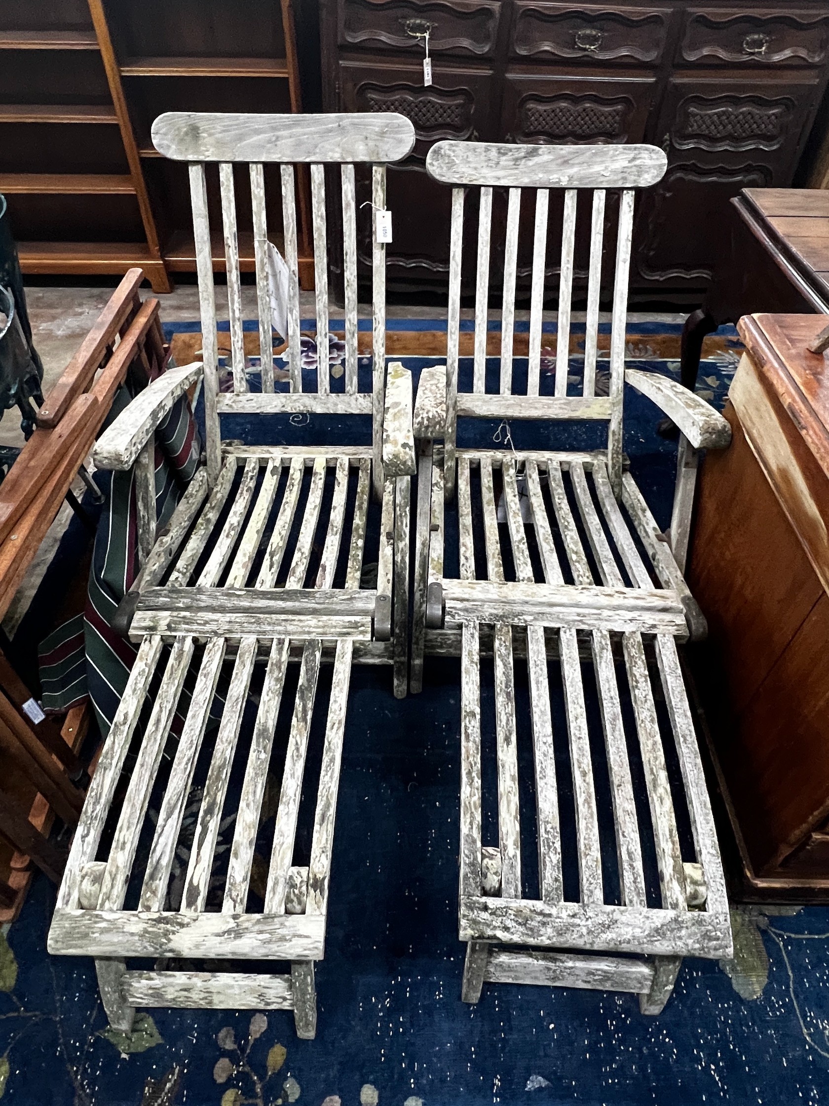 A pair of weathered teak garden steamer chairs and three Sou-wester teak deckchairs